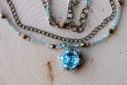 Handwoven Lotus Flower Necklace | Aqua Blue Crystal & Brass Em'z Blendz Soap Co.